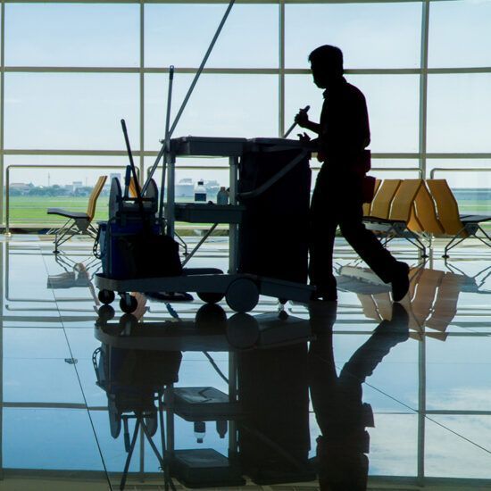 Janitorial cart and reflective floor in institutional setting
